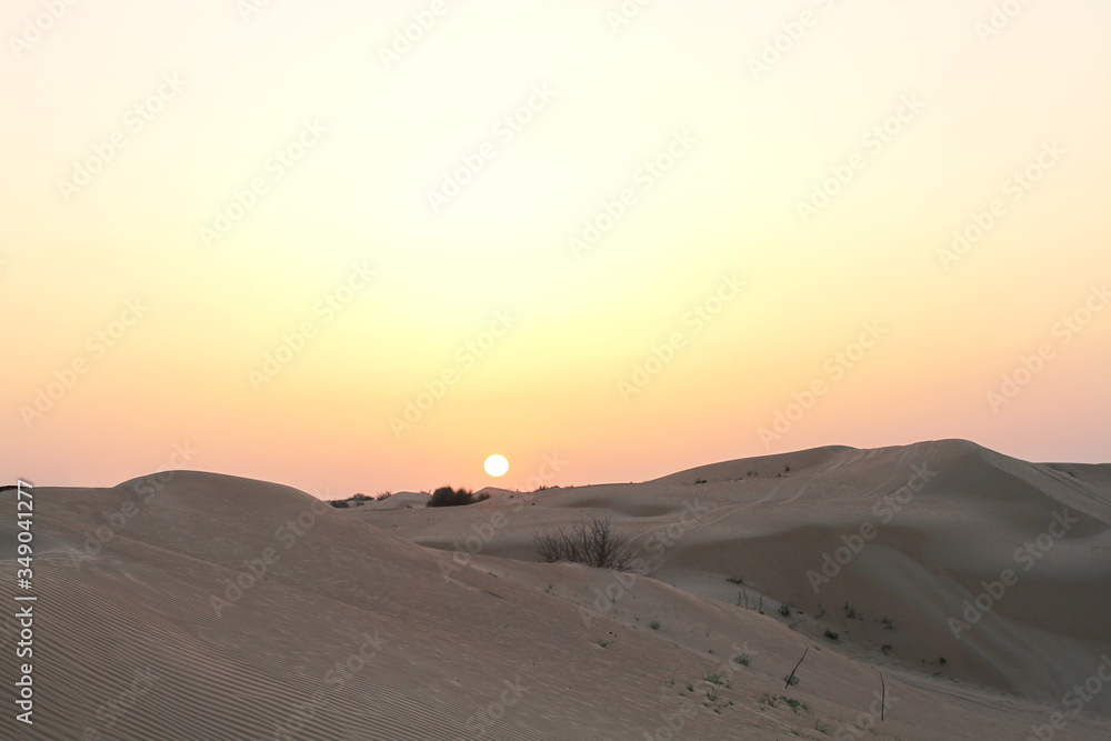 Sunset in the desert. Sand dunes and pink sky Sunset in the desert. Sand dunes and pink sky