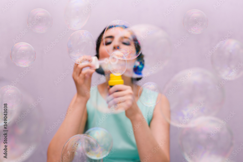 The girl blows soap bubbles. Happy birthday person. A festive event, fun and joy. The girl blows soap bubbles. Happy birthday person. A festive event, fun and joy.