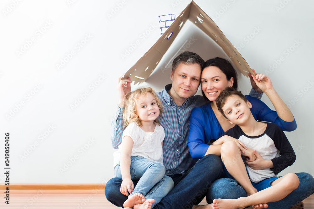 Housing concept of a young modern family. mom dad and children in a new house or apartment Housing concept of a young modern family. mom dad and children in a new house or apartment