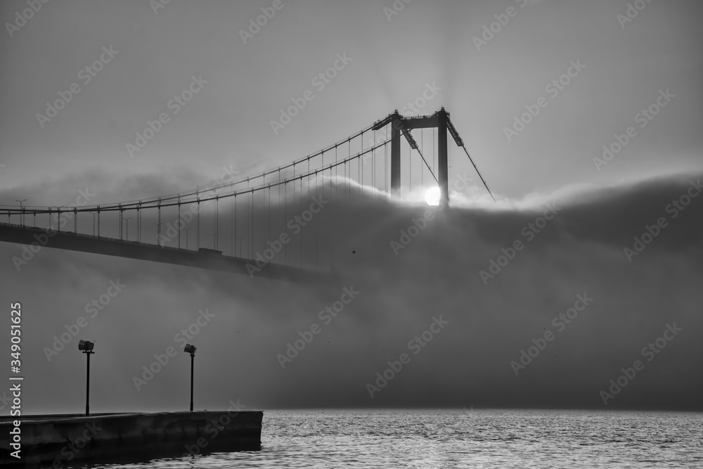 Fototapeta premium Foggy and Misty scene of Bosphorus Bridge. Bridge over the Bosphorus in Istanbul. View from the Asian part of Istanbul. The 15 July Martyrs Bridge in a fog