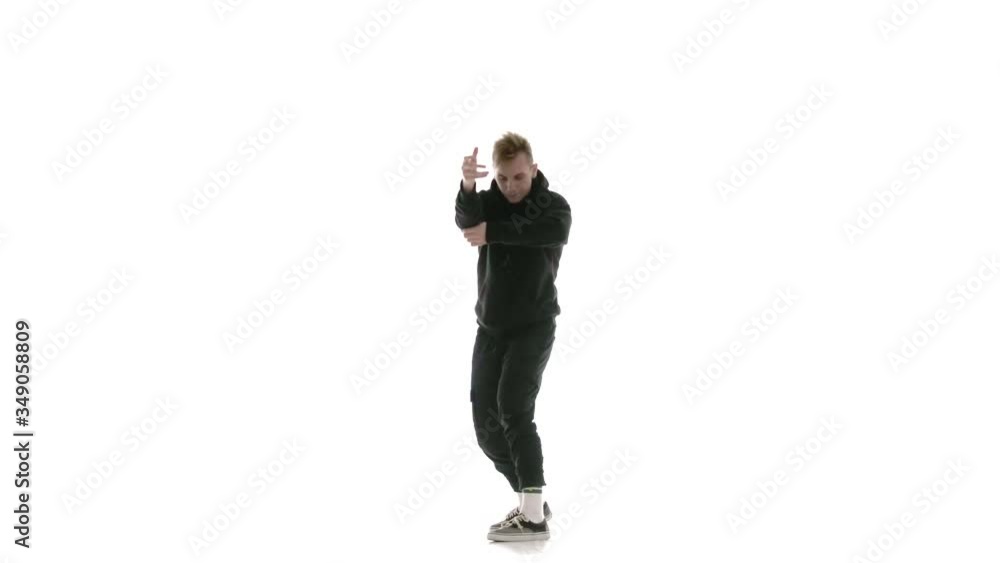 young handsome man in black tracksuit vigorously dancing hip hop, freestyle, street dance, performs complex movements, isolated, slow motion young handsome man in black tracksuit vigorously dancing hip hop, freestyle, street dance, performs complex movements, isolated, slow motion