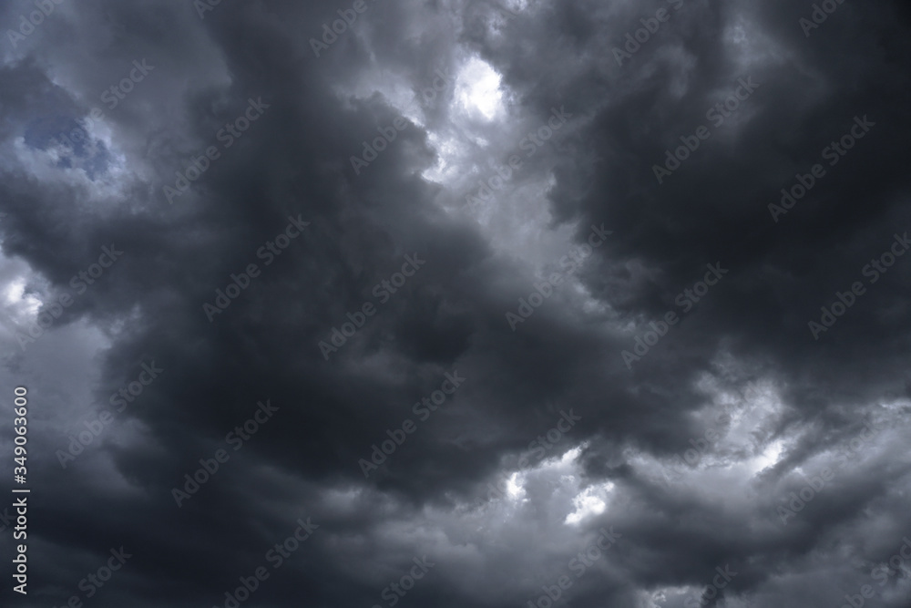 Obraz premium Terrible thunderclouds from the side of a plane. Gloomy epic clouds. Background image in a dark gray style.