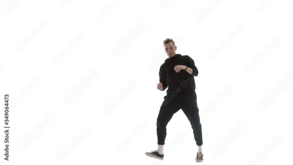 young handsome man in black tracksuit vigorously dancing hip hop, freestyle, street dance, performs complex movements, isolated, slow motion young handsome man in black tracksuit vigorously dancing hip hop, freestyle, street dance, performs complex movements, isolated, slow motion