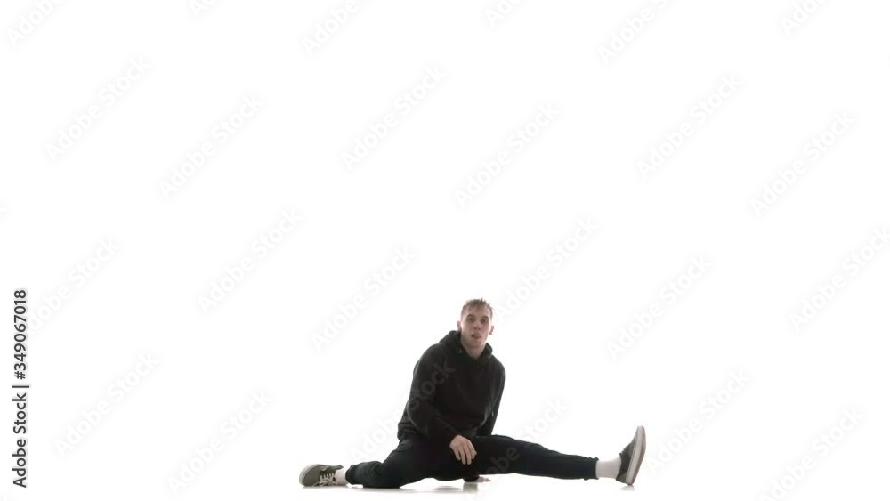 young handsome guy in black tracksuit vigorously dancing hip hop, freestyle, street dance, performs complex movements, isolated, slow motion young handsome guy in black tracksuit vigorously dancing hip hop, freestyle, street dance, performs complex movements, isolated, slow motion