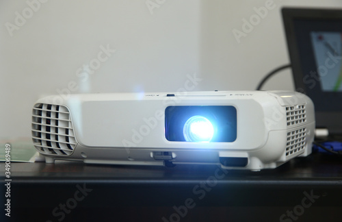 LCD video projector at business conference or lecture in office with copy space. projector on ceiling indoors. LCD video projector at business conference or lecture in office with copy space .