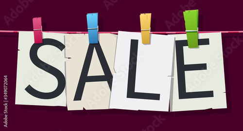 Word "Sale" attached with hairpins