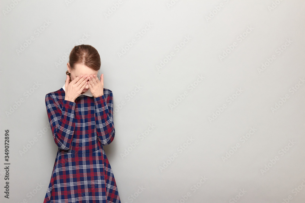 Portrait of unhappy tired girl touching forehead with hands Portrait of unhappy tired girl touching forehead with hands