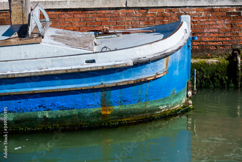 Bow of a colorful boat in Burano chanel, in Italy.