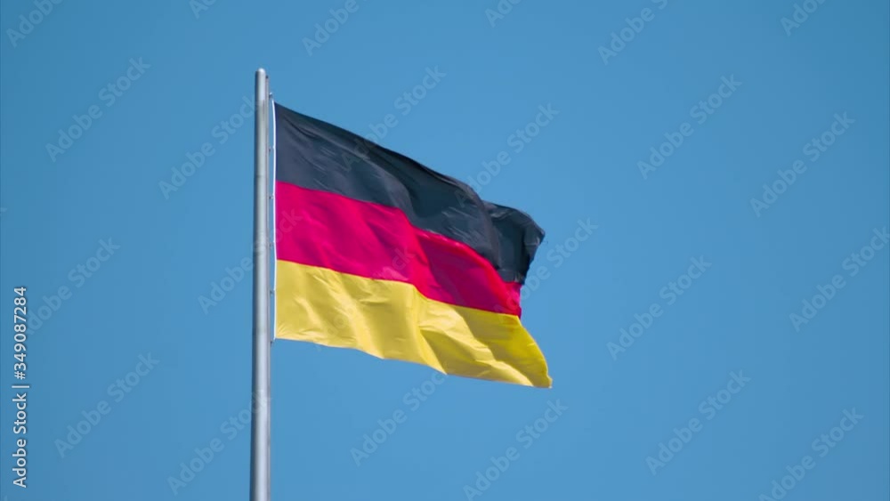 Time lapse of flag of Germany waving from left to right in the wind on a blue sunny day. Medium wide Time lapse of flag of Germany waving from left to right in the wind on a blue sunny day. Medium wide