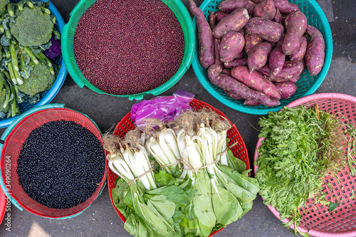 Fresh vegetables for sale at street food market in the old town of Hanoi, Vietnam. Close up