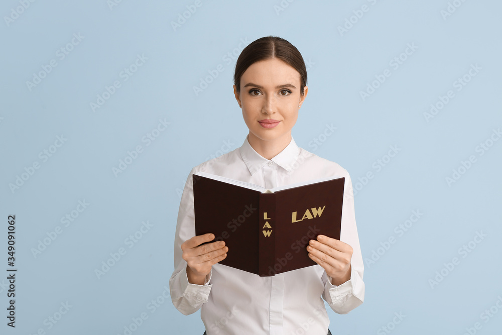 Female judge with book on light background Female judge with book on light background
