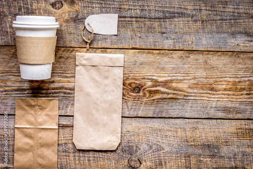 breakfast take away with paper bags on wooden table background top view mock up