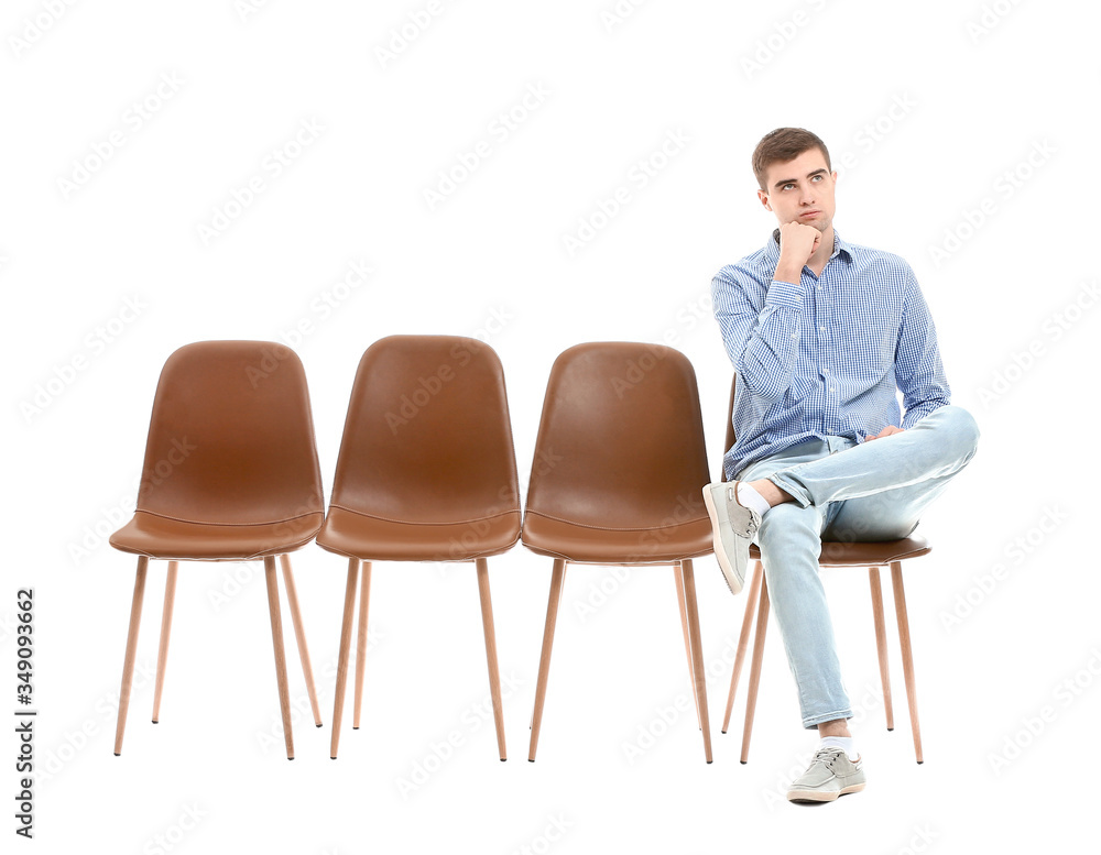 Fototapeta premium Young man waiting for his turn on white background
