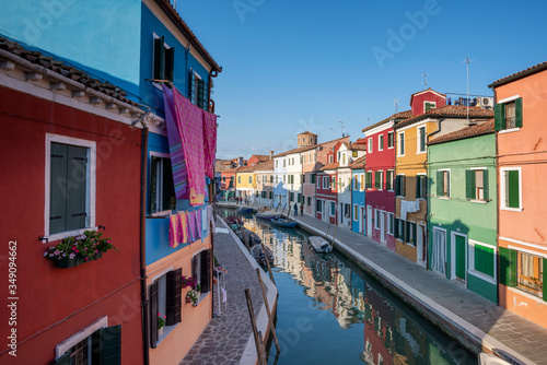 Panoramic view of Burano channel with hanged clothes and colorful houses, in Venice, Italy.
