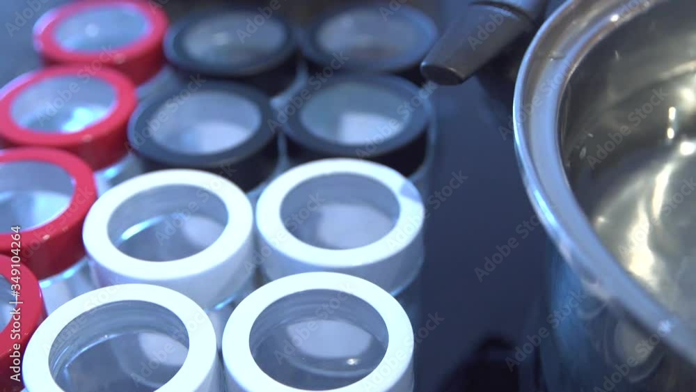 Therapeutic Marijuana Extract In A Jar On Boiling Water For Mass Production Of Herbal Medicine - panning close up shot