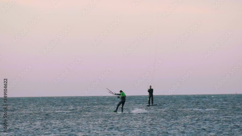 People enjoy parasurfing on the beautiful, calm waves of the Wadden Island - slow motion People enjoy parasurfing on the beautiful, calm waves of the Wadden Island - slow motion