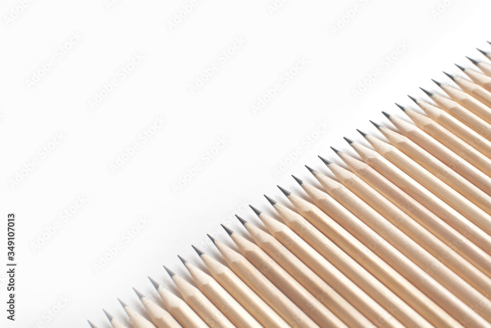 Row of sharpened stationery pencils lie in row with each Row of sharpened stationery pencils lie in row with each