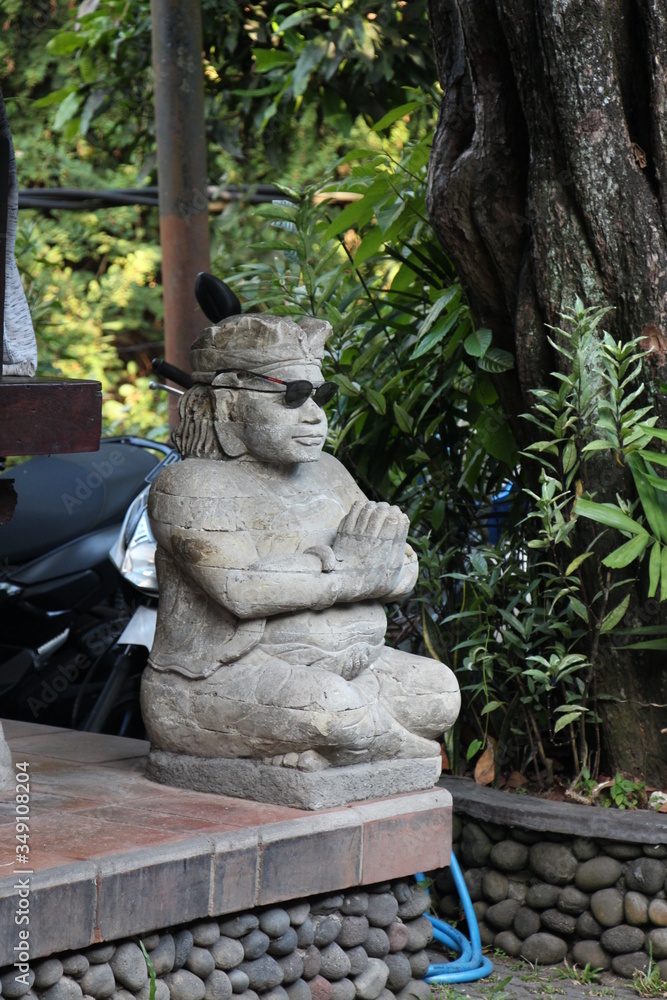 Balinese style statue in sunglasses