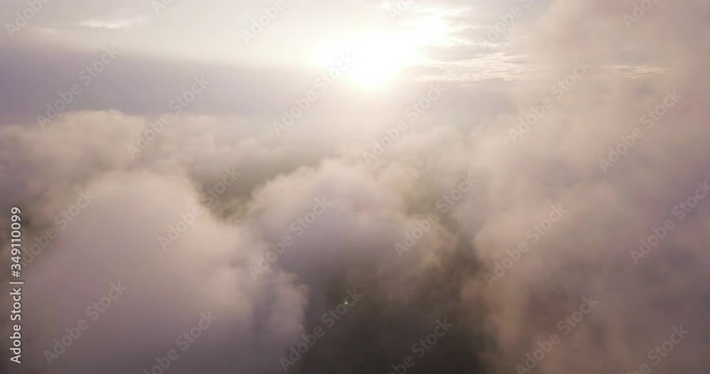 Smooth aerial fly through layer of white clouds covered in golden hour sunlight. Smooth aerial fly through layer of white clouds covered in golden hour sunlight.