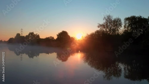 Wallpaper Mural Drone shot above a misty lake while the sunrays are peaking behind the trees Torontodigital.ca
