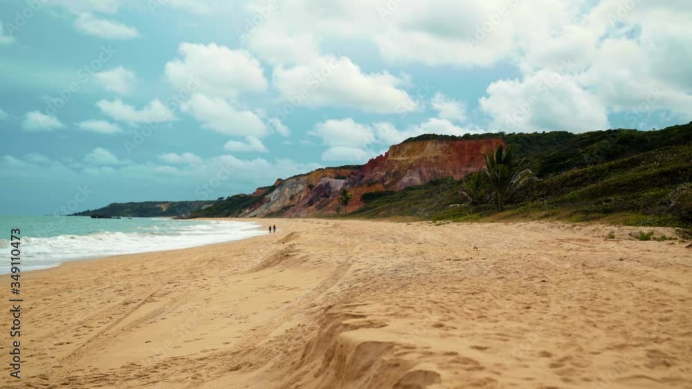 The beautiful tropical coastline at the famous Coquerinhos beach near Joao Pessoa, Brazil with beautiful yellow sand, large colorful cliffs, and clear green water The beautiful tropical coastline at the famous Coquerinhos beach near Joao Pessoa, Brazil with beautiful yellow sand, large colorful cliffs, and clear green water