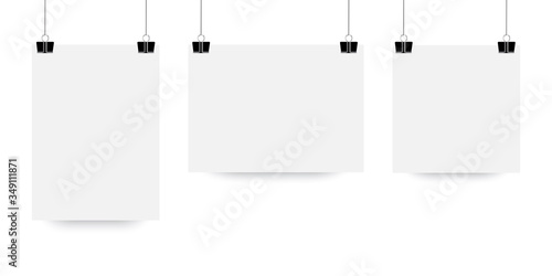 The sheet hangs on the clip. White paper poster in mocap style. A vector template of a suspended light sheet of paper. Stock Photo.