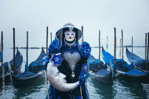 Portrait of a woman with a beautiful blue mask in Venice, Italy