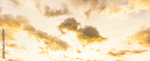 yellow sunset light on white sky and clouds