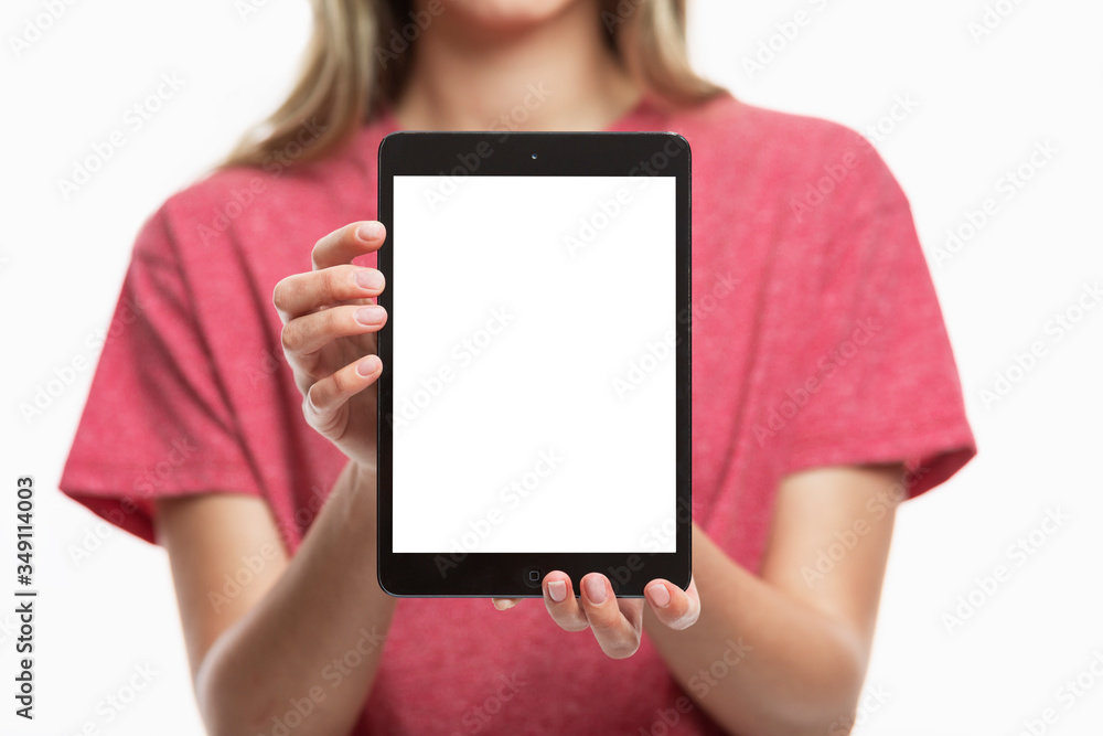 Young girl shows a tablet screen isolated. Close-up. Space for text. Front view. Young girl shows a tablet screen isolated. Close-up. Space for text. Front view.