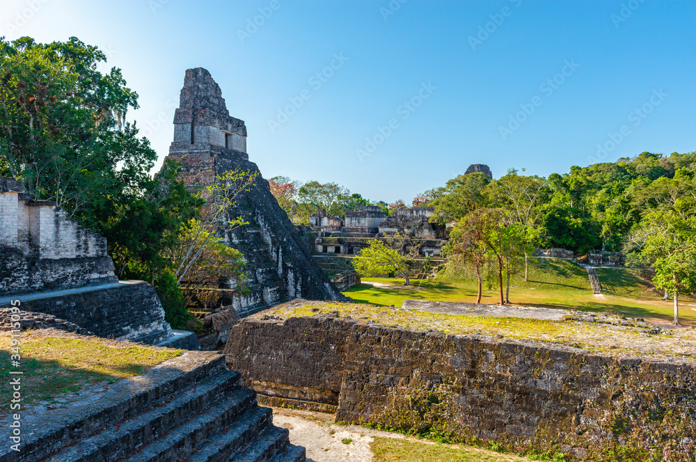 Main Square of the Mayan archaeological site of Tikal with Temple I or Temple of the Great Jaguar Pyramid on the left, Peten Rainforest, Guatemala.