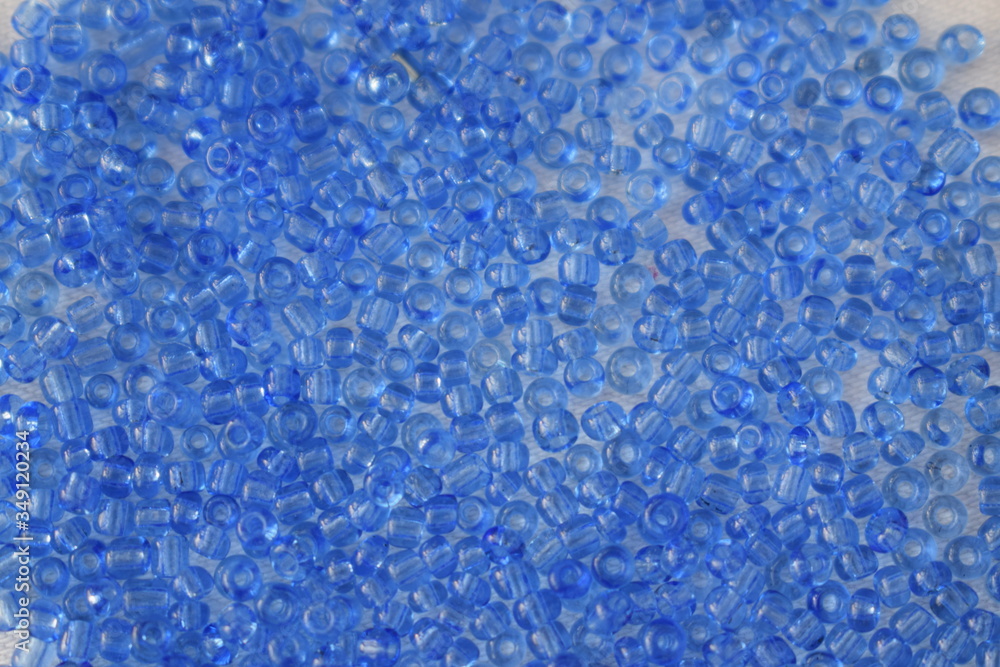 Blue beads scattered on a white background. Blue beads scattered on a white background.