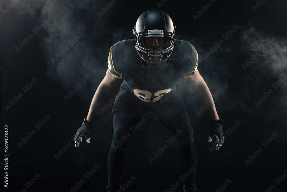 African American football player isolated on black. African American football player isolated on black.