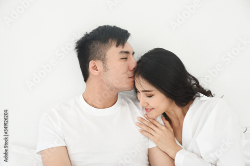 asian couple kiss in the bed