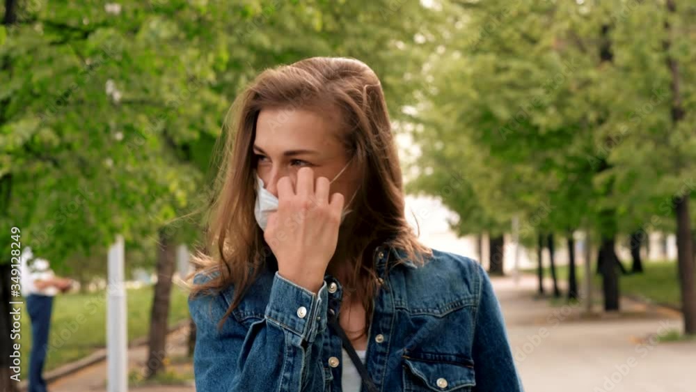 Young woman takes off the face mask. The end of quarantine, epidemic. Happy smile Young woman takes off the face mask. The end of quarantine, epidemic. Happy smile