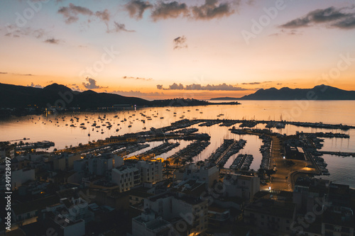 AERIAL View over Golden Sunset in Harbor Bay with Boats in Spain