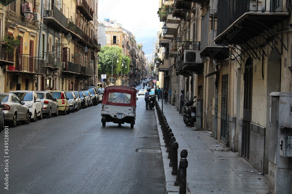 evocative image of three-wheeled scooter for tourists in transit in a street in Palermo, Italy
