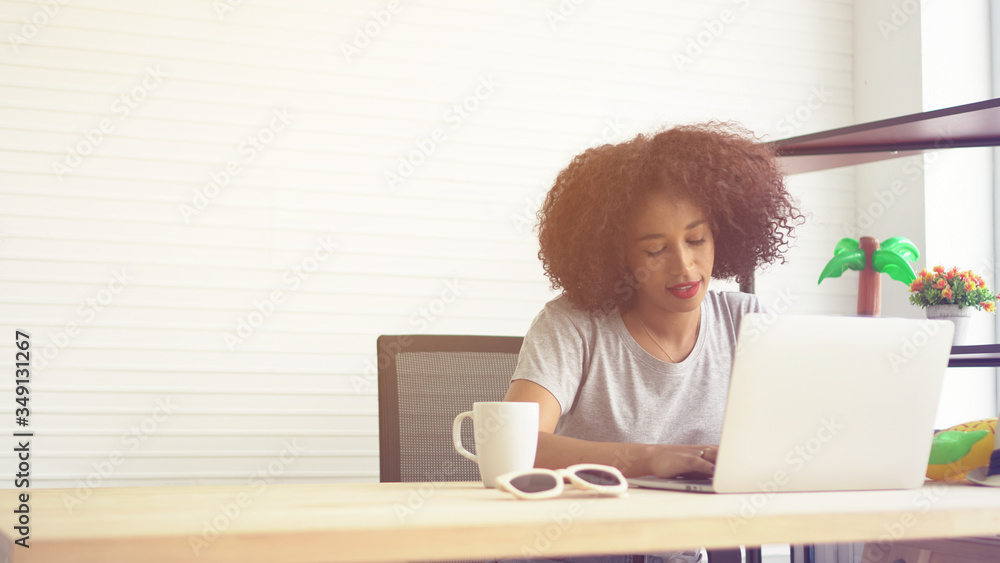 African woman working from home notebook and cup of coffee African woman working from home notebook and cup of coffee