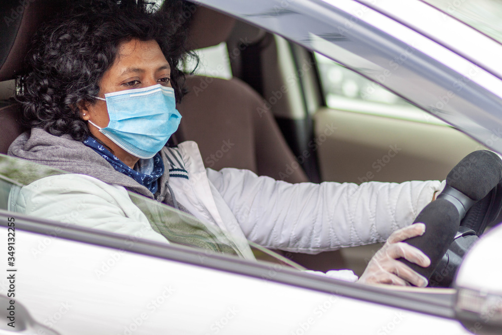 A woman wearing protective mask and gloves during quarantine during corona virus Covid-19 outbreak A woman wearing protective mask and gloves during quarantine during corona virus Covid-19 outbreak