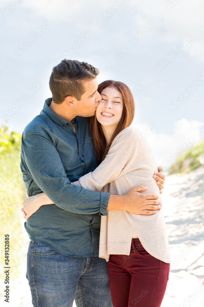 Portrait of a happy couple walking on the beach. Portrait of a happy couple walking on the beach.