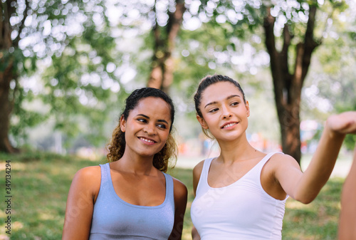 Couple of young sporty woman standing together at public park in the morning,Happy and smiling,Relaxing time