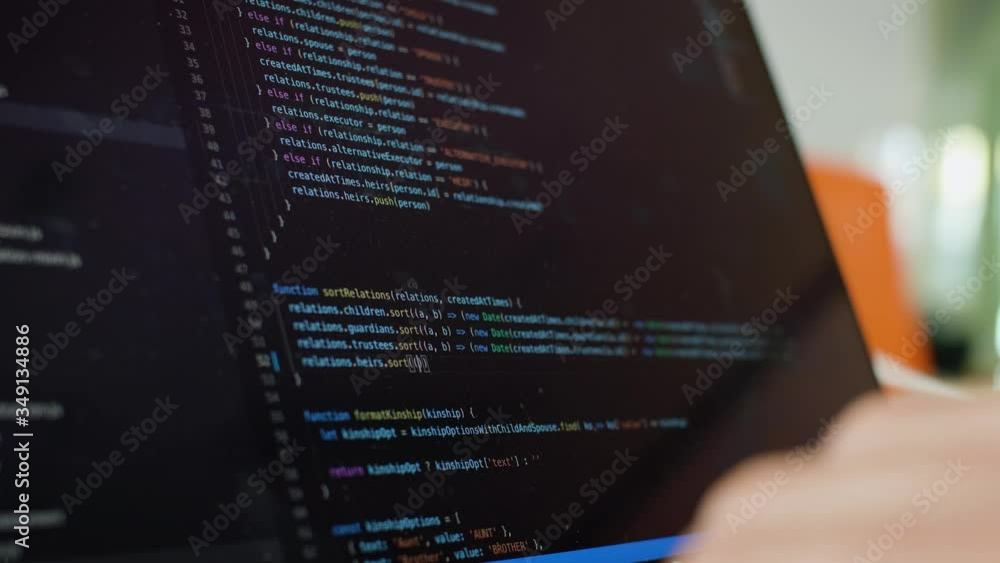 Writing code on laptop. Software Developer writes code from home. Remote Work and Freelance Concept.