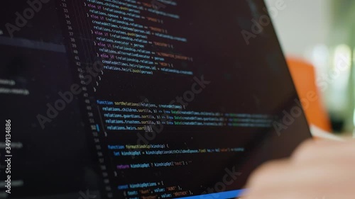 Writing code on laptop. Software Developer writes code from home. Remote Work and Freelance Concept.