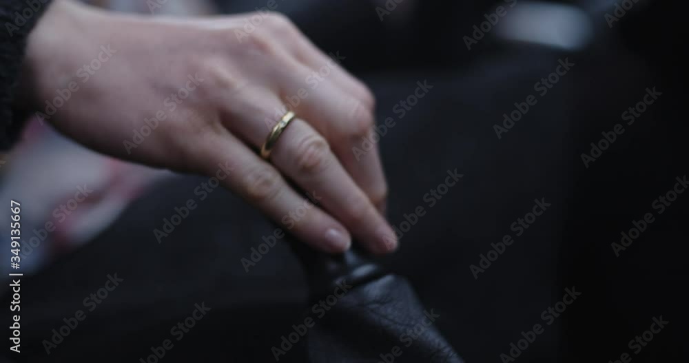 Woman driving a car and manually changing gears. Closeup handheld shot. Woman driving a car and manually changing gears. Closeup handheld shot.
