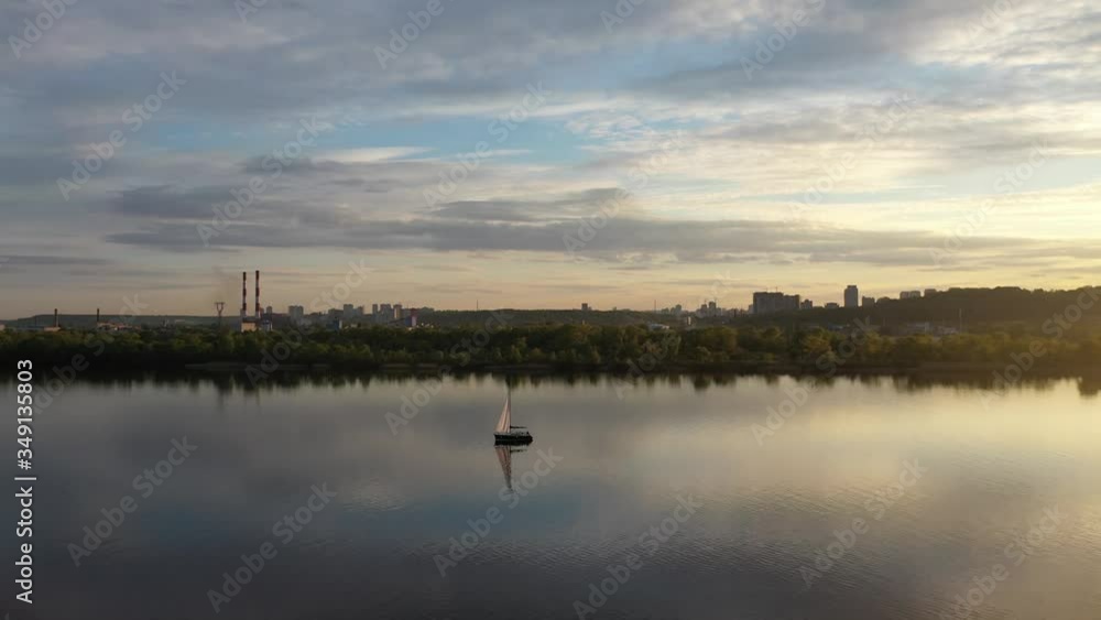 Sailing yacht on the smooth surface of the river. Dnipro River Ukraine, spring Sailing yacht on the smooth surface of the river. Dnipro River Ukraine, spring