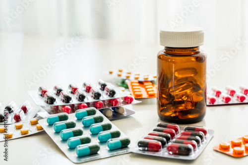 A lot of Colorful Medicine pills, tablets and capsules in packaging and bottle.