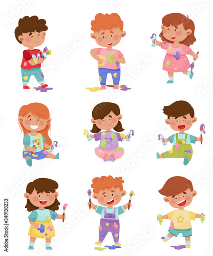 Playful Children in Stained Clothes Holding Paintbrushes and Paints Vector Illustrations Set © Happypictures