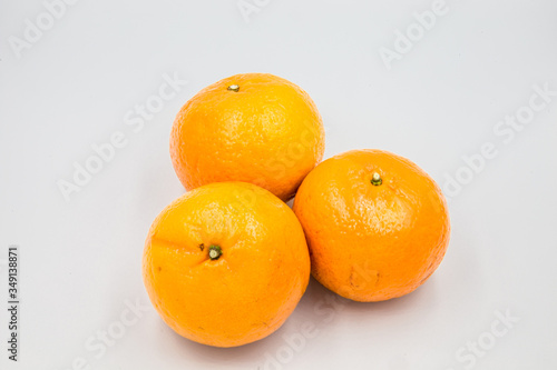Three oranges were placed on a white ground.