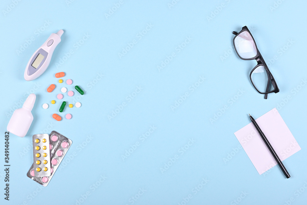 Medical pills on blue background, flat lay, overhead view image. Medical pills on blue background, flat lay, overhead view image.