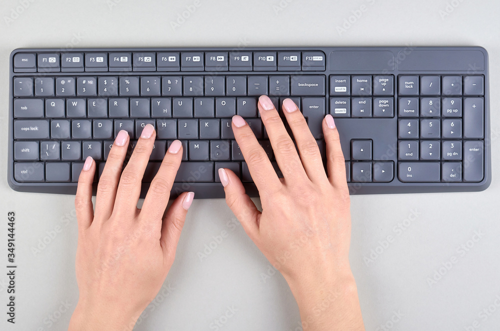 Hands with keyboard on grey background. Hands with keyboard on grey background.