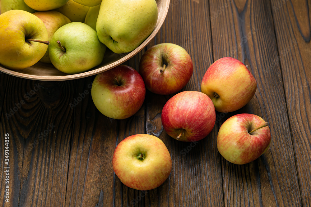 Green and red apples on wooden background